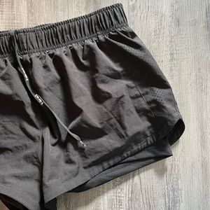 Black running shorts with spandex underneath. Size L